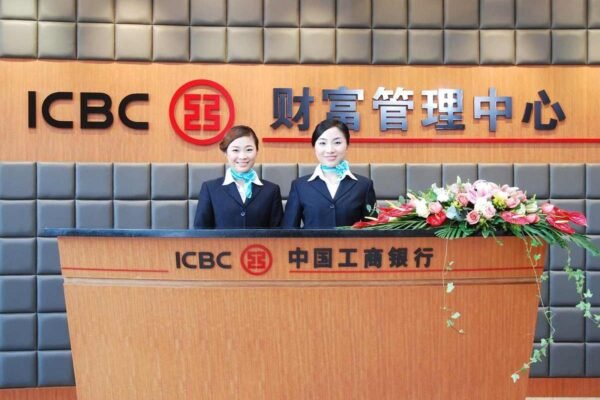 Deux femmes en uniforme devant un bureau ICBC avec des fleurs